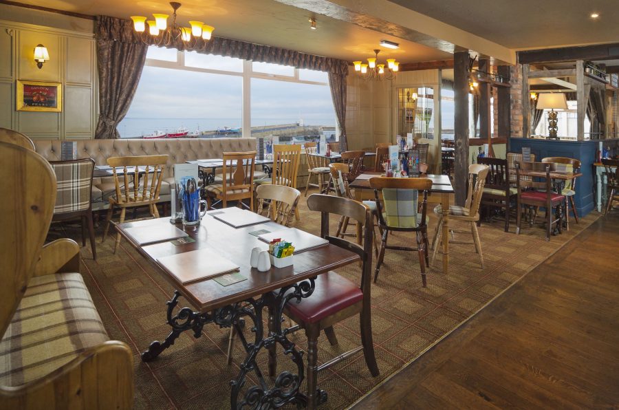 bam2-bamburgh-castle-inn-dining-area-overlooking-seahouses-harbour